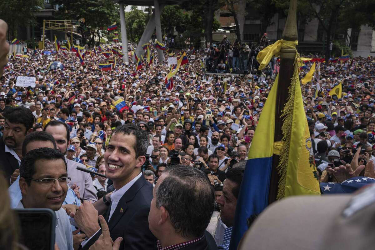 Juan Guaido, president of the National Assembly who swore himself in as the leader of Venezuela, smiles as he arrives during an opposition rally in Caracas, Venezuela, on Monday, March 4, 2019.