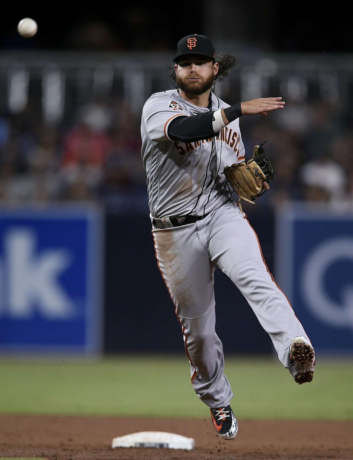 San Francisco Giants shortstop Brandon Crawford throws to first to force out San Diego Padres' Franchy Cordero during the third inning of a baseball game in San Diego, Friday, April 13, 2018. (AP Photo/Kelvin Kuo)