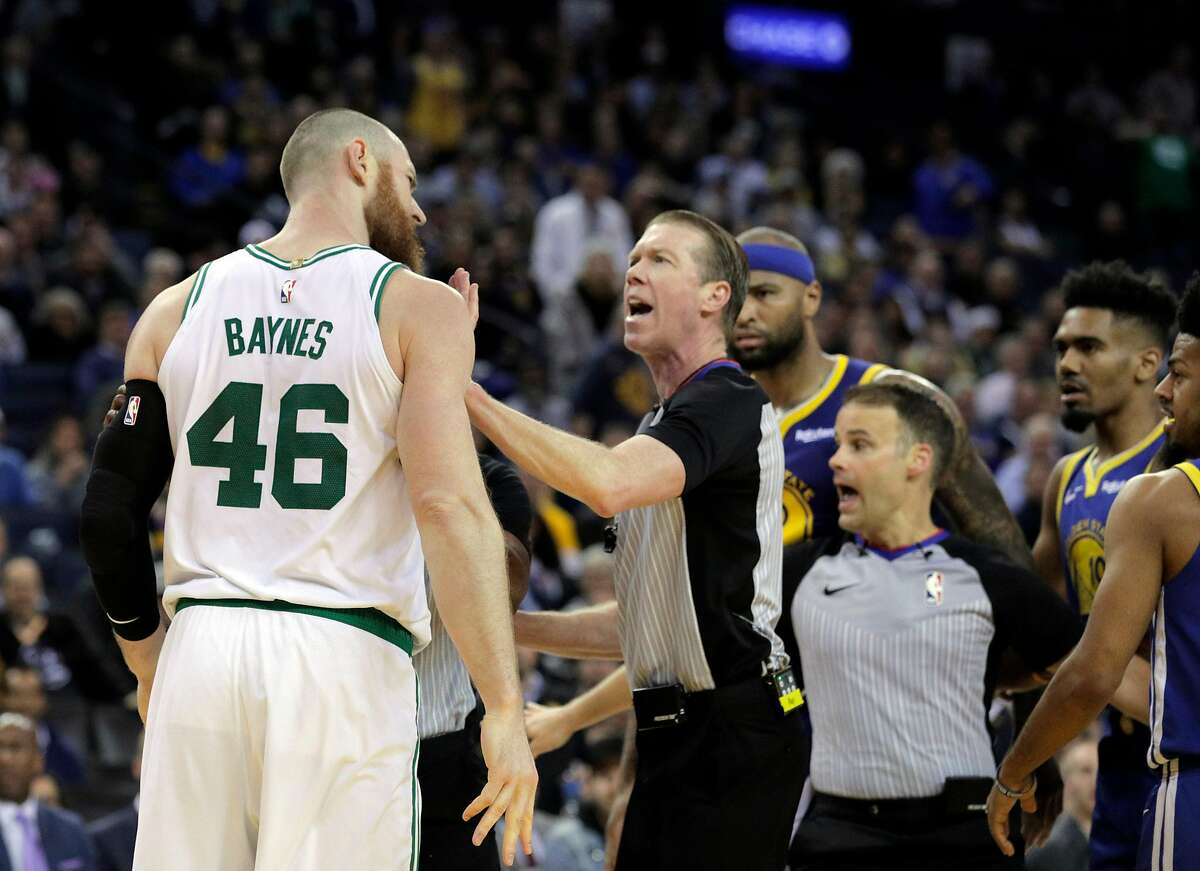 Referees separate Aron Baynes (46) and DeMarcus Cousins (0) after a brief scuffle after Cousins was called for an offensive foul late in the second half as the Golden State Warriors played the Boston Celtics at Oracle Arena in Oakland, Calif., on Tuesday, March 5, 2019.