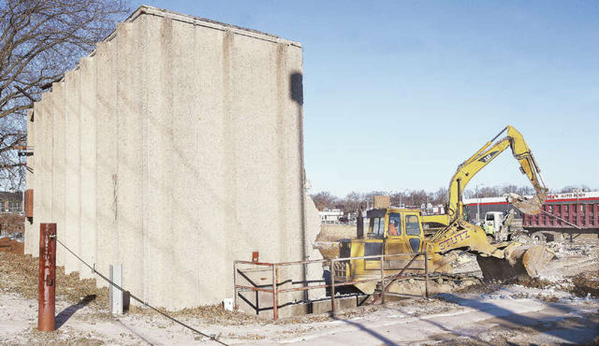 Just a portion of the rear wall of the long-closed Alton Cine in Alton was all that was left standing Wednesday morning as workers from Stutz Excavating made quick work of the demolition of the building. The theater had been closed since March 28, 1998.
