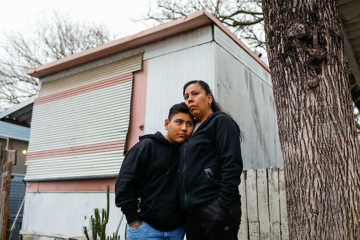 Anthony Villatoro Lopez, 14, and his mother Areli Lopez stand for a portrait outside their trailer home in Sacramento, California, on Tuesday, March 5, 2019. Areli's husband and Anthony's father, Christian Villatoro has been detained by ICE for over a year and they are anxiously waiting for him to be released.