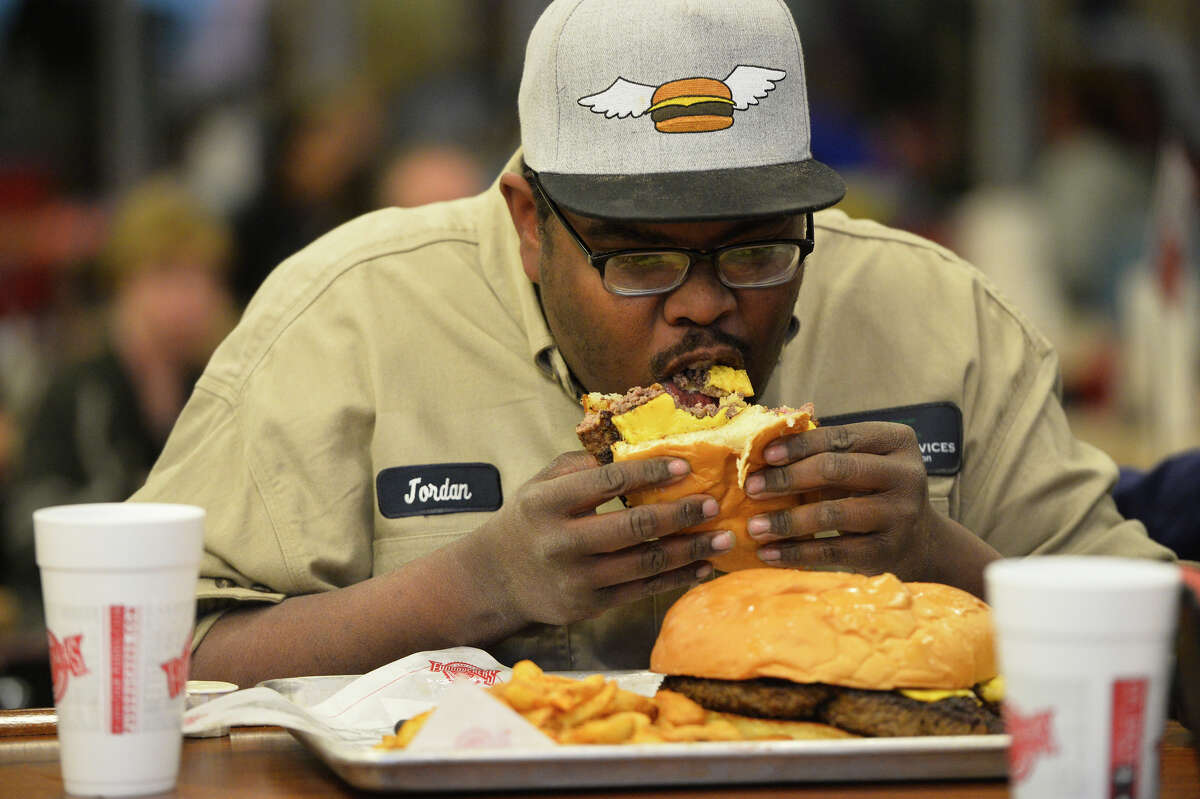 Jordon Rasoure competes in a three-pound burger challenge March 6, 2019, at Fuddruckers in Midland Park Mall. Contestants attempted to eat the burger, oversize bun, and a pound of fries in one hour. James Durbin / Reporter-Telegram