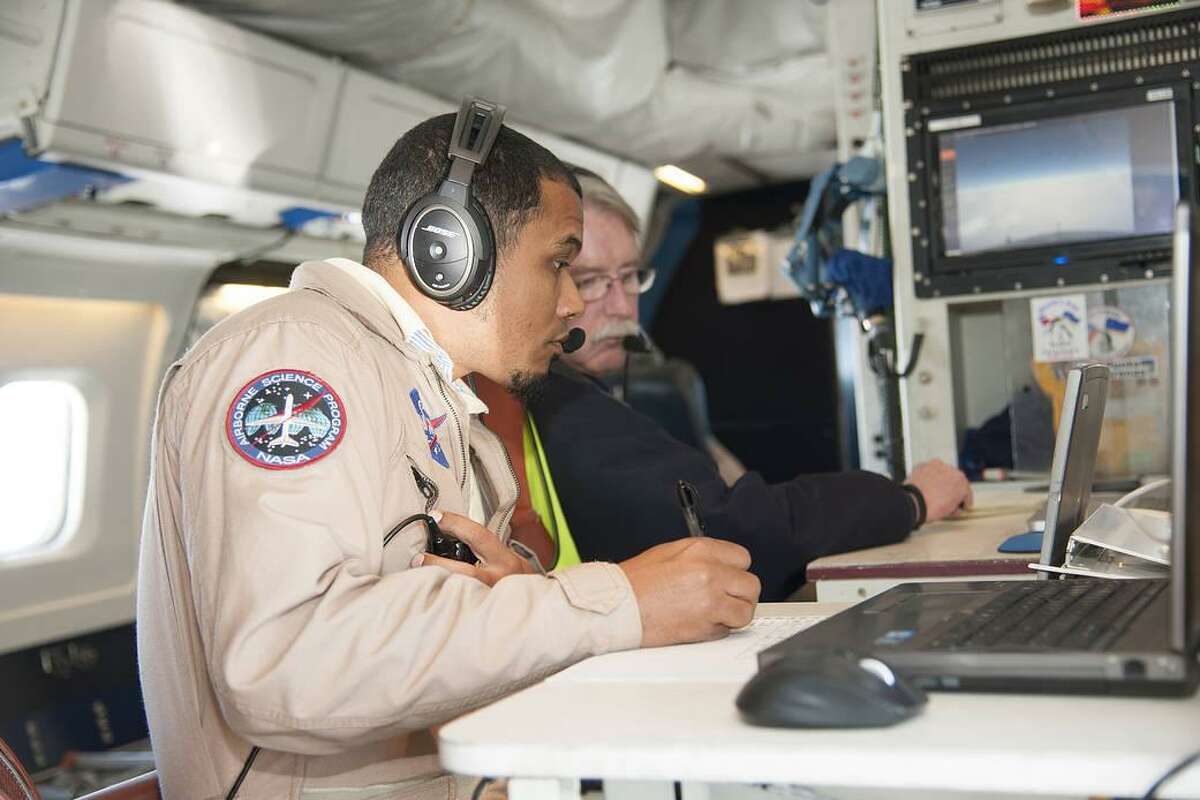 Mission managers Matt Berry, left, and Chris Jennison work aboard NASA’s DC-8 Flying Laboratory during its Polar Winds mission in Iceland in 2015.