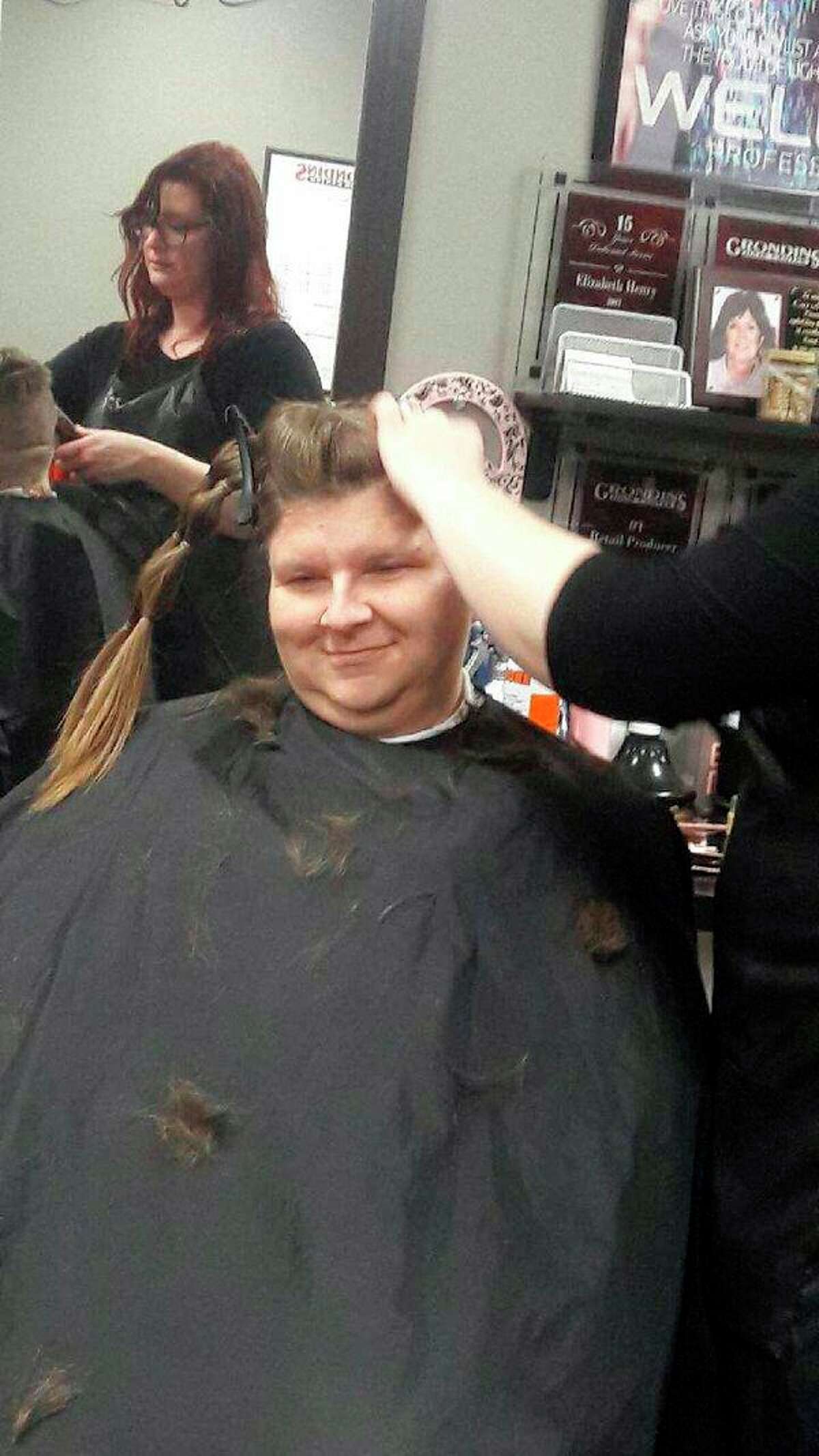 Members First Credit Union employee Melanie Duke while her head is shaved. (Photo provided)