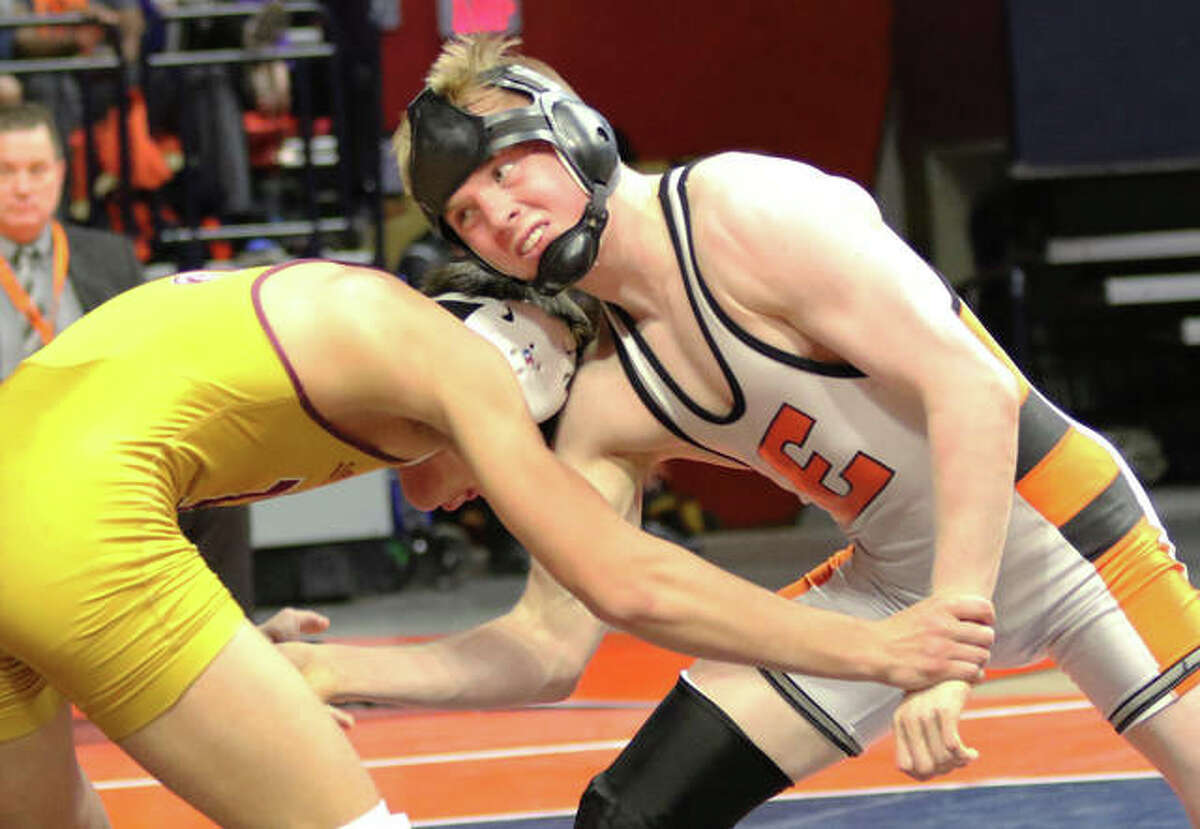 Edwardsville’s Noah Surtin (right) wrestles Lockport’s Matt Ramos in the 120-pound championship match at the Class 3A state tourney Saturday night at State Farm Center in Champaign.