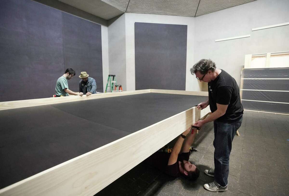 Laramie Justice, on floor, and Scott Peveto, right, along with other Crate Works employees crate one of the paintings in the Rothko Chapel Wednesday, March 6, 2019, in Houston. All of the Mark Rothko canvases will be moved ahead of a major renovation.