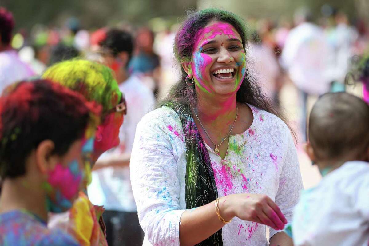 A Holi attendee rubs colored powder on fellow revelers during the Holi festival on Saturday, March 3, 2018, at the Hindu Temple of The Woodlands. This year’s event at the temple along South Forestgate Drive is scheduled from noon to 4 p.m. March 16.
