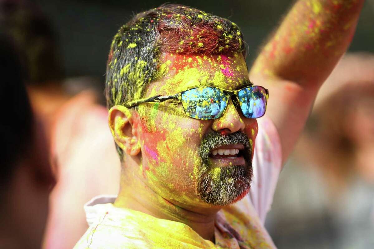 An attendee is pictured covered in colored powder during the annual Holi festival on Saturday, March 3, 2018, at the Hindu Temple of The Woodlands. This year’s event at the temple along South Forestgate Drive is scheduled from noon to 4 p.m. March 16.