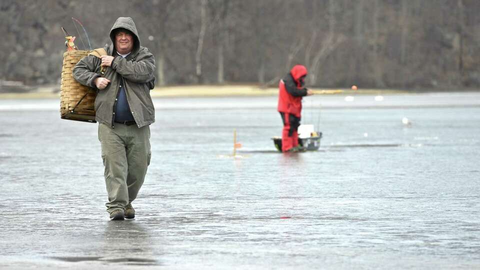 Chris Giordano, of Danbury, walks off the ice after ice fishing on Candlewood Lake, off Danbury Town Park in 2016.