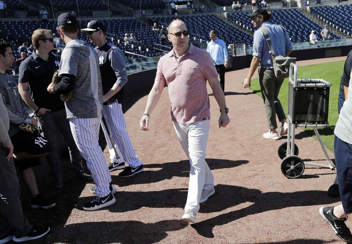 New York Yankees general manager Brian Cashman walks on the field at the Yankees spring training baseball facility, Thursday, Feb. 14, 2019, in Tampa, Fla. (AP Photo/Lynne Sladky)
