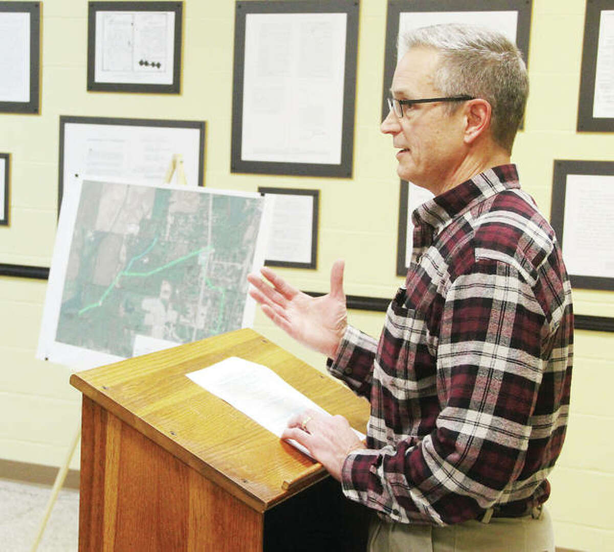 Curtis A. Westrich, an engineer with Heneghan and Associates, talks about the Northeast Interceptor/Monticello Area Sanitary Sewer Improvement project during a public hearing on a proposed low-interest loan to pay for the project. The hearing was held Tuesday before the Godfrey Village Board meeting in Godfrey Village Hall. The village is seeking to borrow $3.5 million for the project.