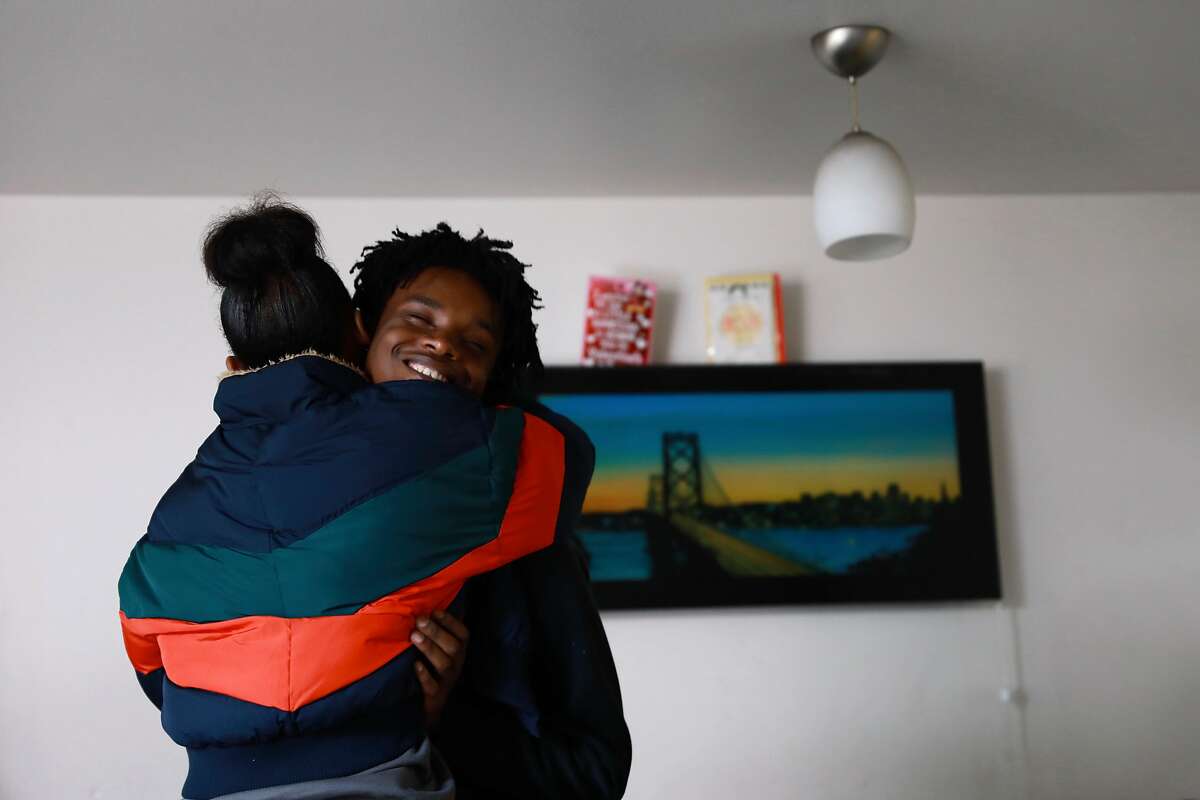 Terrance Hall, 18, receives a hug from his first cousin Angie Kyer in his Valencia Gardens apartment in San Francisco, Calif.,on Wednesday, March 6, 2019. Hall faces a possible eviction from his home. The property manager of SF's public housing is trying to evict Hall, a high school senior, after his grandmother passed away last month. It's turned into a big legal battle.