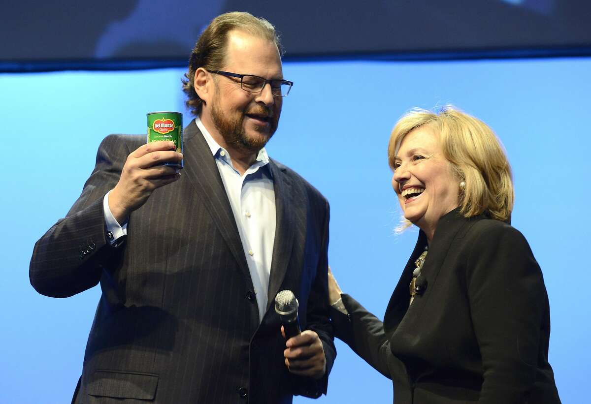 SAN FRANCISCO, CA - OCTOBER 14: Marc Benioff (L) and Hillary Rodham Clinton speak at Salesforce.com's Dreamforce 2014 Conference at Moscone South on October 14, 2014 in San Francisco, California. ~~