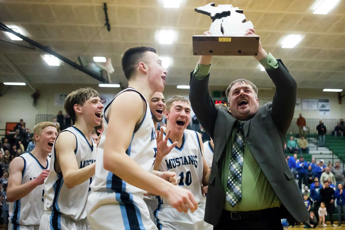 Meridian head coach Mitch Bohn celebrates after the Mustangs' 65-44 Division 3 regional finals victory over Oscoda on Thursday, March 7, 2019 at Houghton Lake High School. (Katy Kildee/kkildee@mdn.net)