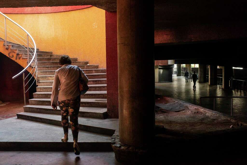 A woman walks through a nearly empty mall in the heart of Caracas on Feb. 14, 2019.