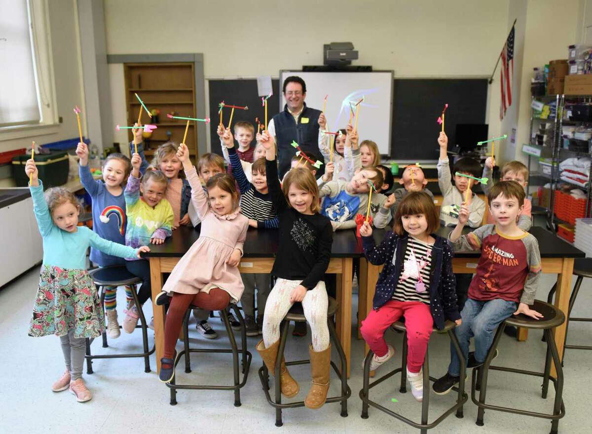 Kindergarteners show their homemade weather vanes during a visit from the Talcott Mountain Science Center at Old Greenwich School in Old Greenwich, Conn. Wednesday, Feb. 20, 2019. The school recently installed a fully-equipped weather station that gives accurate temperature, wind and barometric readings.