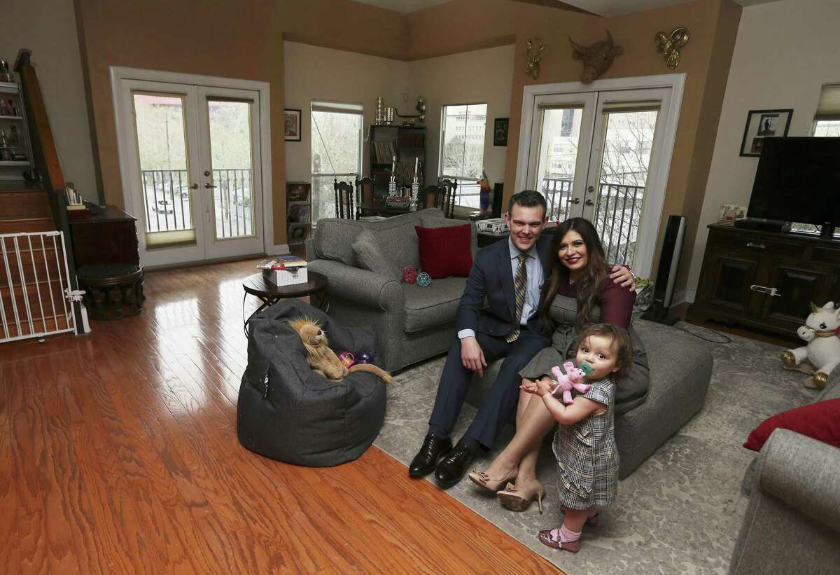Attorney T.J. Mayes and his wife, Laura Elizabeth, and their toddler Marisa rent their home in downtown San Antonio. They enjoy the amenities and conveniences that downtown living provides but are undecided if they will stay after their lease ends or opt to move to a more traditional residential community. (Kin Man Hui/San Antonio Express-News)