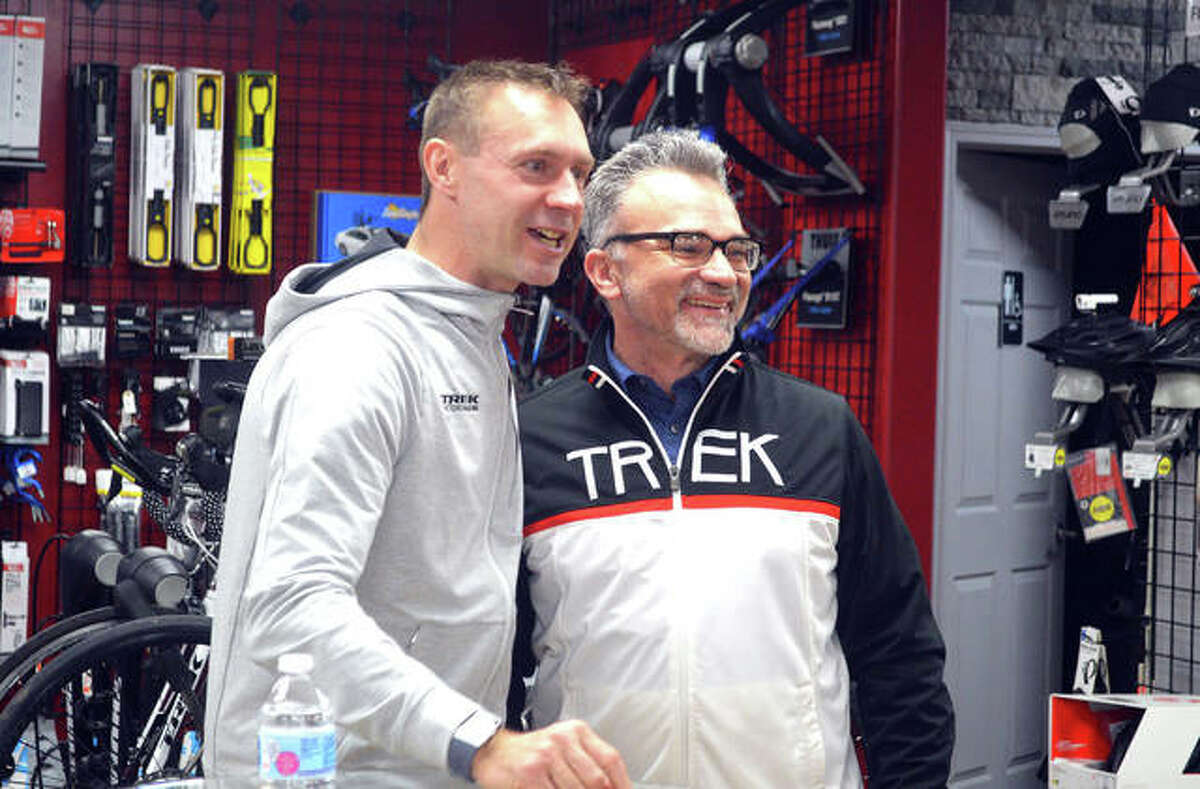 Retired German cyclist Jens Voigt, left, poses for a photo with Troy Gilmore, of Springfield during Voigt’s promotional appearance on Thursday night at the Cyclery in Edwardsville.