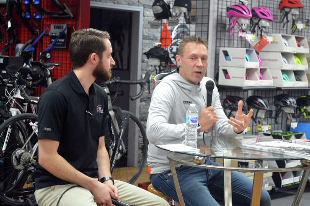 Retired German cyclist Jens Voigt, left, talks during a question-and-answer session as part of a promotional appearance on Thursday night at the Cyclery in Edwardsville. Store manager David Parks is seated next to Voigt.