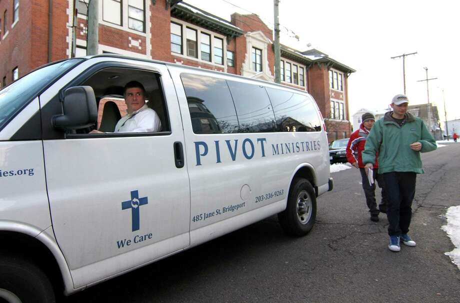 Troy Magnuson, a case manager at Pivot Ministries, drops off members from New Vision International Ministries at the ministry building on Jane Street in Bridgeport, Conn., on Thursday Mar. 7, 2019. Magnuson picked up several members to receive counseling. Over 40 men live and work at Pivot Ministries, which counsels and treats them for drug and alcohol addiction. Photo: Christian Abraham / Hearst Connecticut Media / Connecticut Post