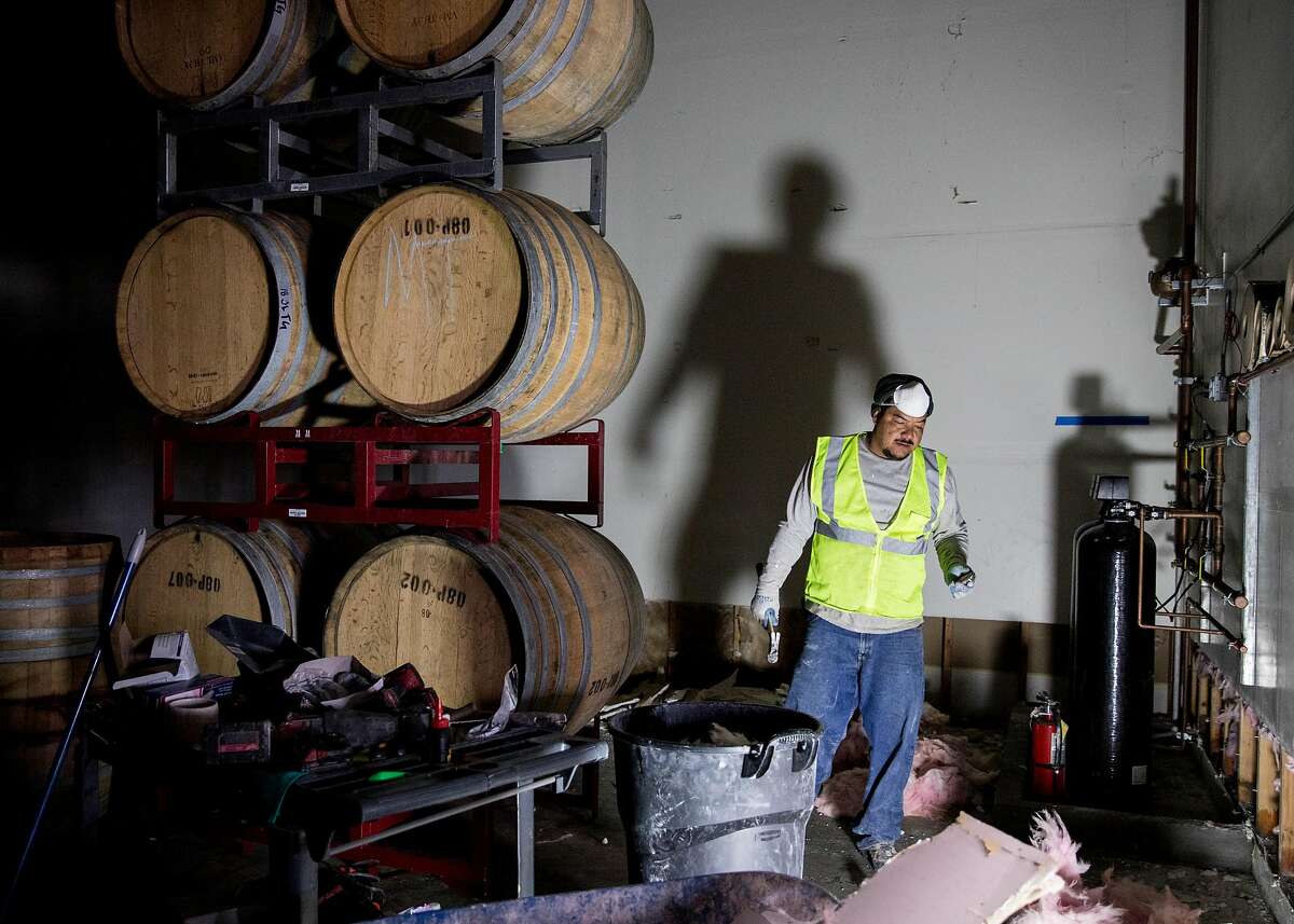 Crews work to remove drywall and continue to clean up damage caused by floodwaters inside Pax Wines at The Barlow shopping plaza in Sebastopol, Calif. Friday, March 8, 2019.