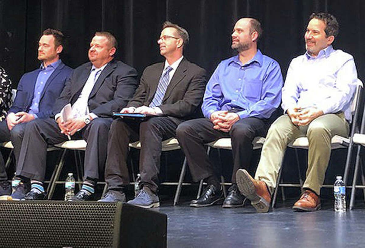 While moderator Rachel Tompkins speaks to the audience, five of the six Edwardsville City Council candidates wait their turn to speak during a meet and greet event at the Wildey Theatre Wednesday. From left are Will Krause, Brent Daniels, Art Risavy, Robert Turner and Chris Farrar. Not pictured is Alderman Janet Stack, who was absent. Krause and Daniels are opponents, as are Turner and Farrar, while Risavy and Stack run unopposed.