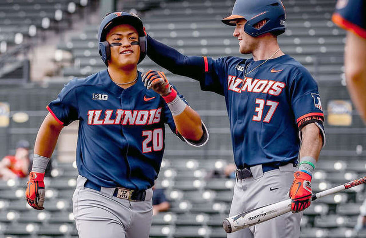 Branden Comia of Illinois (20) is congratulated by teammate Zac Taylor during a recent Illini baseball game. Illinois visits Grand Canyon this weekend in its first trip to the state of Arizona since 2001.