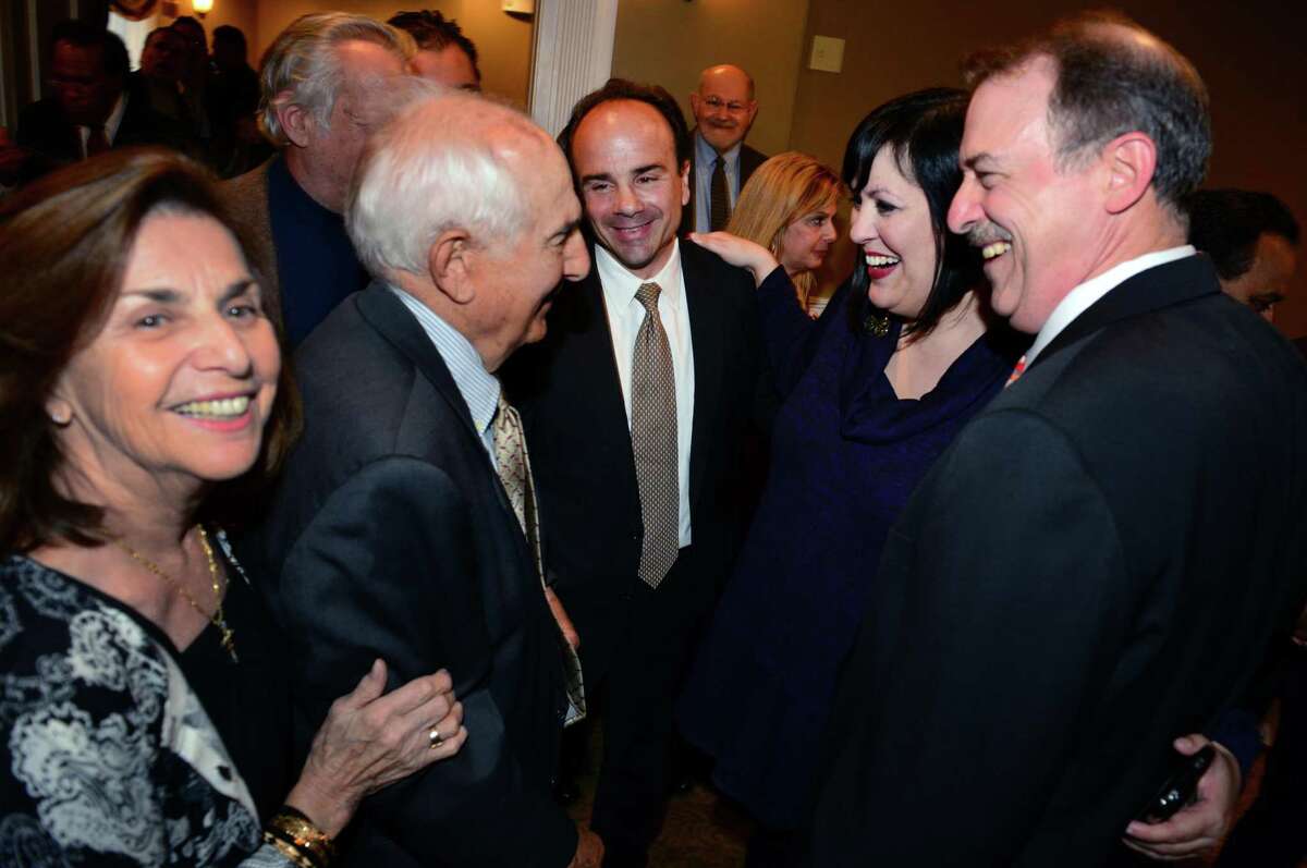 Former Bridgeport Mayor Joseph P. Ganim, center, stands with his parents Josephine, left, and George Sr.. during a fundraising event for Ganim at Vazzano's Four Seasons in Stratford, Conn., on Thursday Apr. 23, 2015. At right is Ben Walker with Maria Pereira.