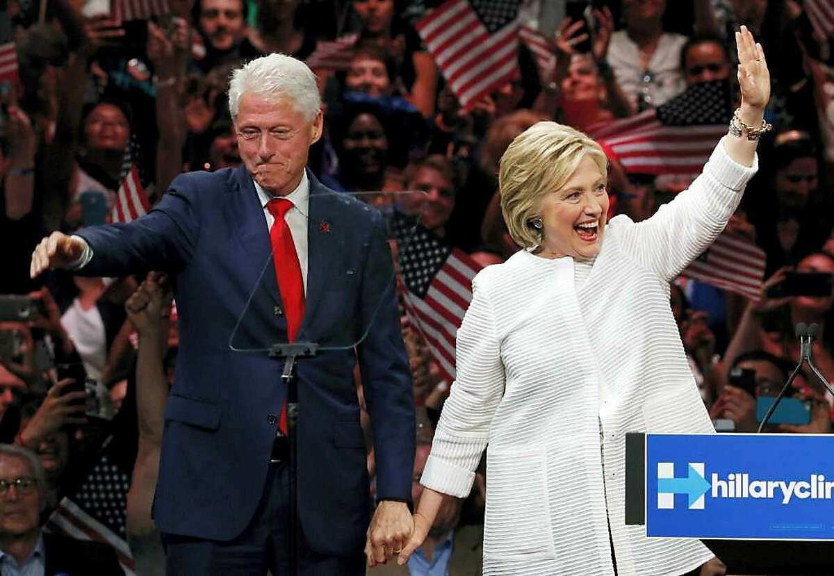 In this Nov. 8, 2016, file photo, Democratic presidential candidate Hillary Clinton, and her husband former President Bill Clinton, greet supporters after voting in Chappaqua, N.Y.