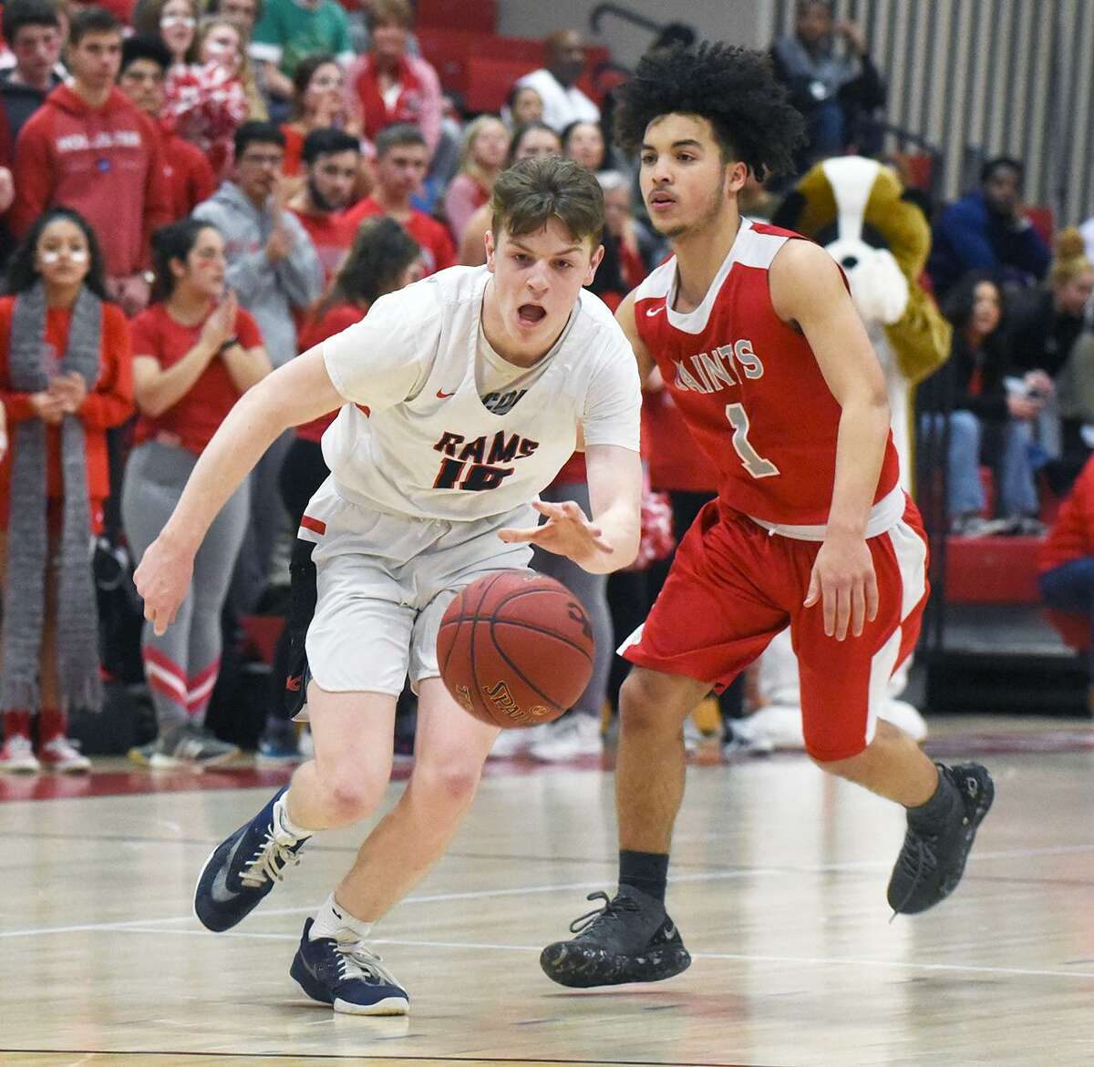 New Canaan’s Ryan McAleer (10) gets out in front of St. Bernard’s Frank Pacheco during a CIAC Division IV quarterfinal game at New Canaan High on Friday.