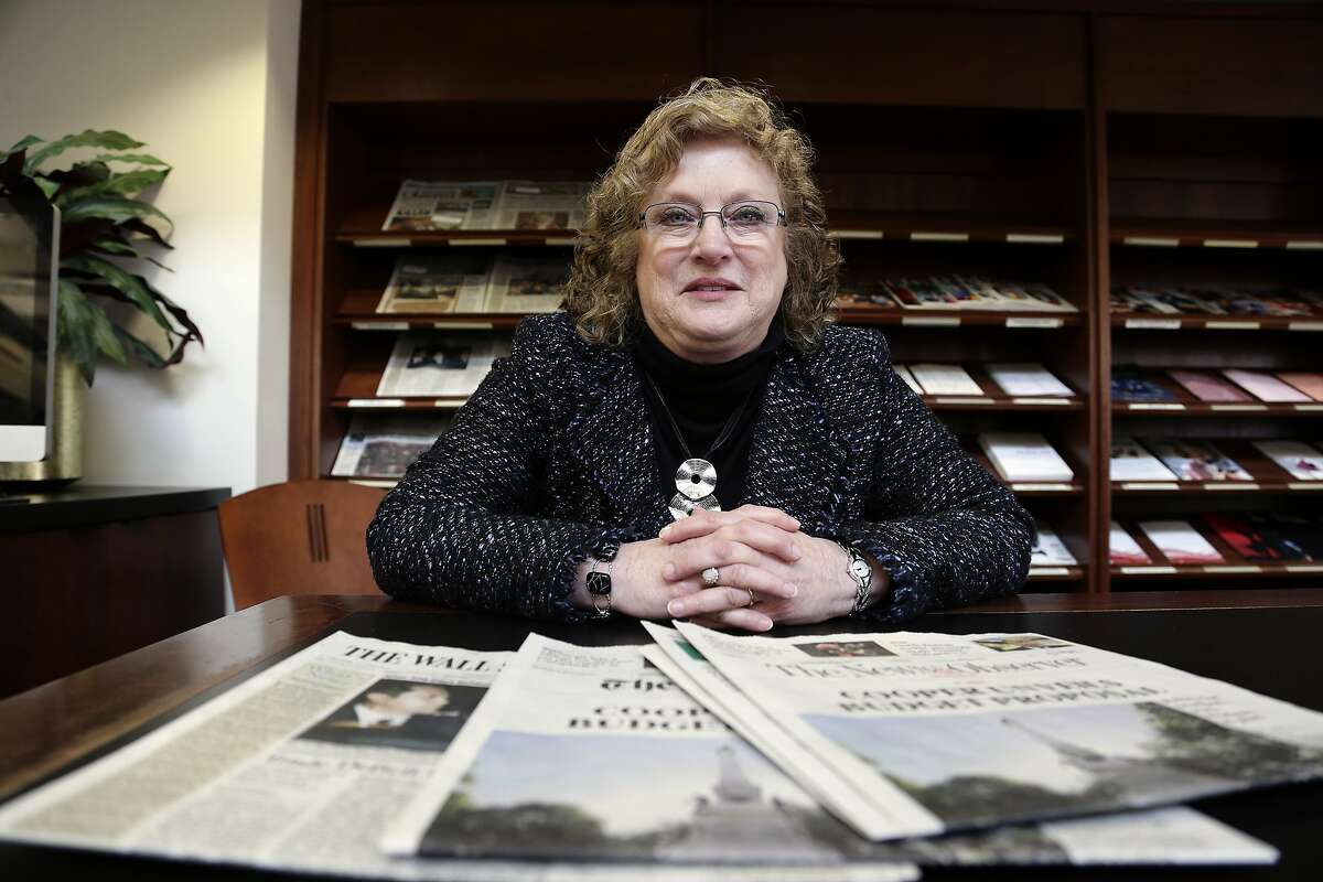 ADVANCE FOR USE SUNDAY, MARCH 10, 2019 AND THEREAFTER-Penelope Muse Abernathy, a University of North Carolina professor, stands with the daily newspaper selection in the Park Library at the School of Journalism in Chapel Hill, N.C., on Thursday, March 7, 2019. "Strong newspapers have been good for democracy, and both educators and informers of a citizenry and its governing officials. They have been problem-solvers," said Abernathy, who studies news industry trends and oversaw the "news desert" report released the previous fall. (AP Photo/Gerry Broome)