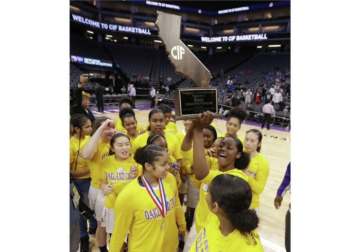 Oakland Tech players celebrate after beating Northview High School 55-37 in the CIF girls' Division IV state high school basketball championship game, Saturday, March 9, 2019, in Sacramento, Calif.(AP Photo/Rich Pedroncelli)