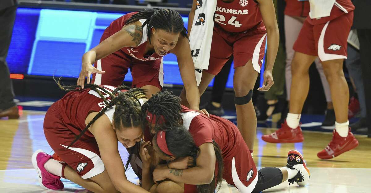 Arkansas players celebrate after defeating Texas A&M in an NCAA college basketball game in the Southeastern Conference women's tournament Saturday, March 9, 2019, in Greenville, S.C. (AP Photo/Richard Shiro)
