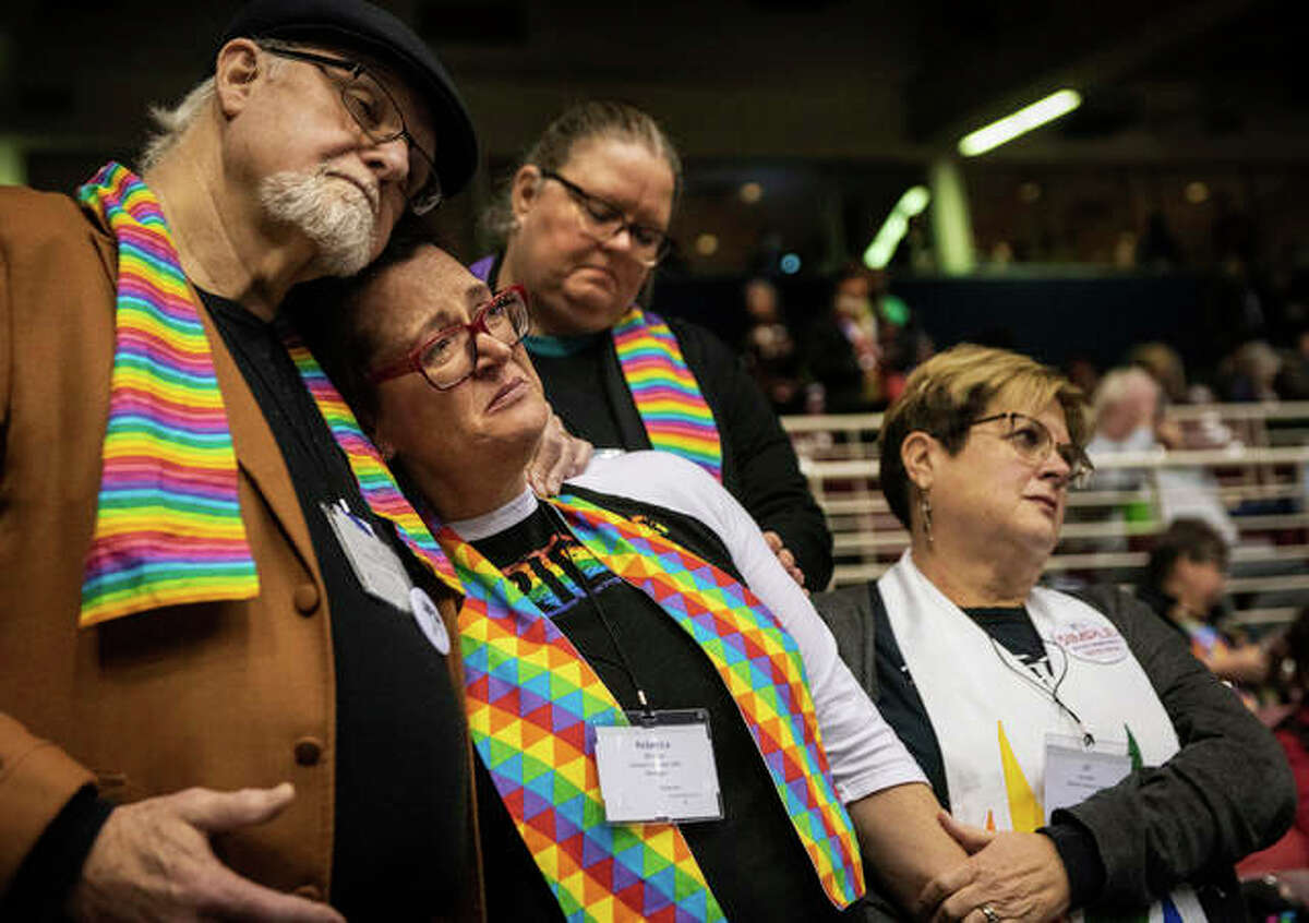 Ed Rowe, left, Rebecca Wilson, Robin Hager and Jill Zundel, react to the defeat of a proposal that would allow LGBT clergy and same-sex marriage within the United Methodist Church at the denomination’s 2019 Special Session of the General Conference in St. Louis, Mo., Tuesday, Feb. 26, 2019. America’s second-largest Protestant denomination faces a likely fracture as delegates at the crucial meeting move to strengthen bans on same-sex marriage and ordination of LGBT clergy. (AP Photo/Sid Hastings)