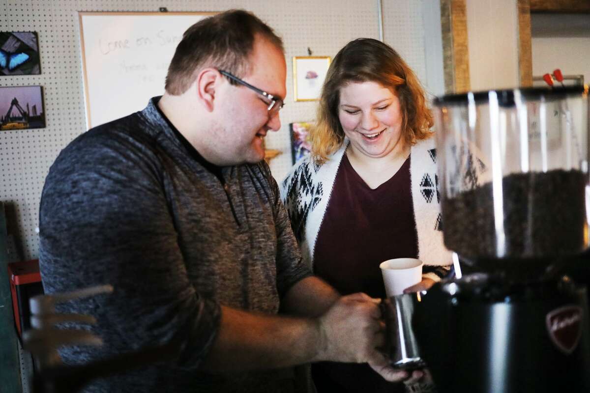 Brett Nowak, left, and Maegan Ross, right, prepare coffee drinks at their mobile coffee stand, Pioneer Coffee Catering, inside The Tax Cafe on Thursday, March 7, 2019 in Midland. (Katy Kildee/kkildee@mdn.net)