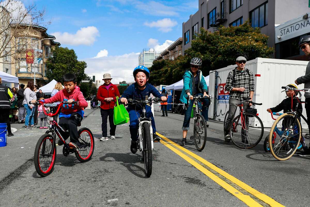 Jordan Hong, 8 (left) and Guus Vroegh, 8 (center) ride their bikes with friends during Sunday Streets where Valencia Street was car-free and open for the public to enjoy in San Francisco, California, on Sunday, March 10, 2019.
