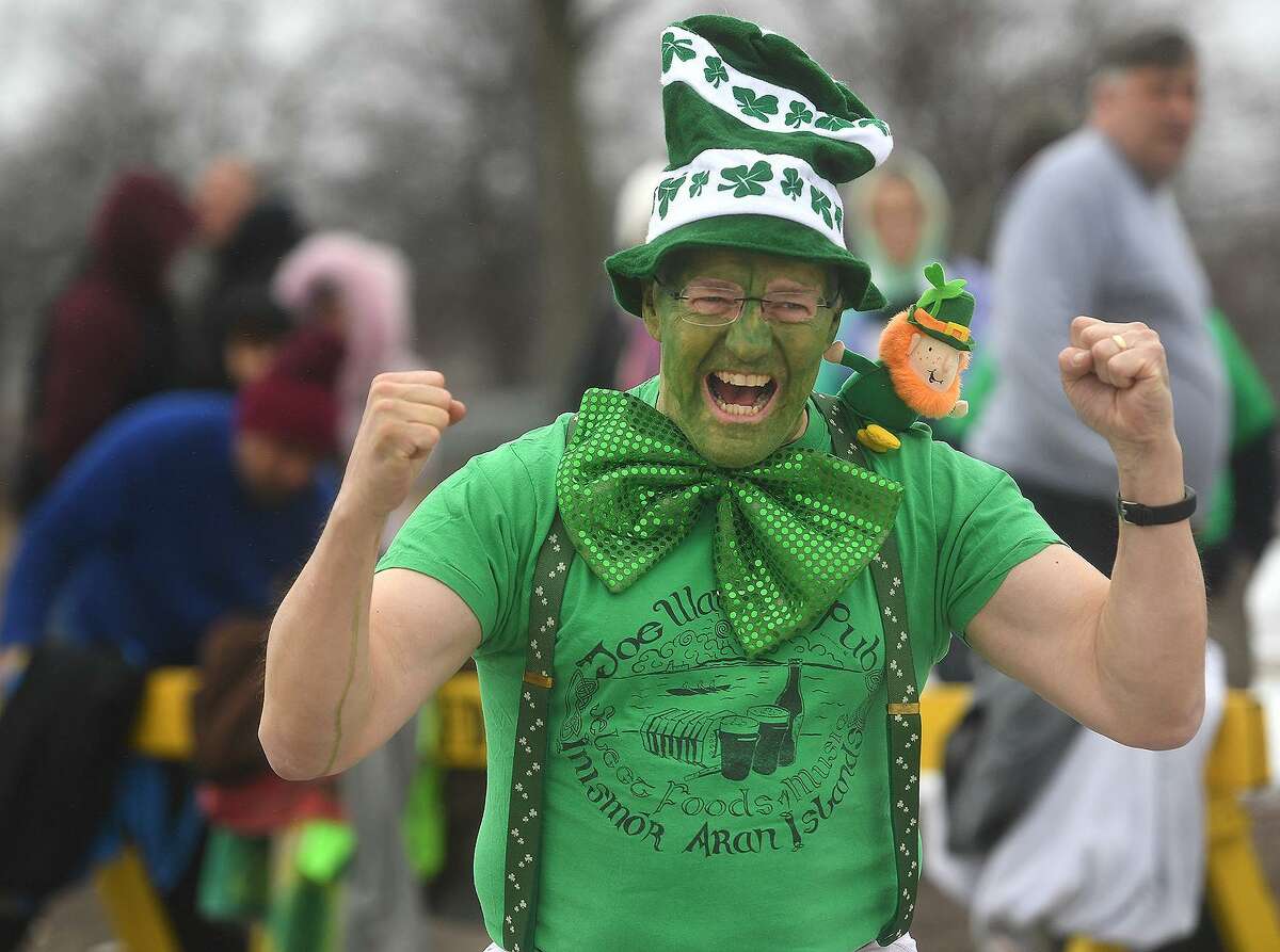 Eric Twombly, of Milford, gets pumped up before running into the Sound during the Literacy Volunteers of Southern Connecticut's annual Leprechaun Leap at Walnut Beach in Milford, Conn. on Sunday, March 10, 2019.