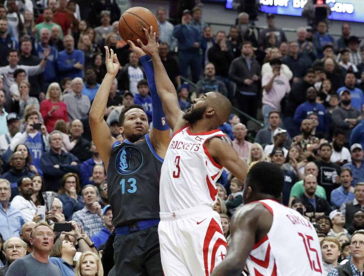 Dallas Mavericks guard Jalen Brunson (13) has his shot blocked by Houston Rockets guard Chris Paul (3) as Clint Capela (15) watches in the final seconds of an NBA basketball game in Dallas, Sunday.