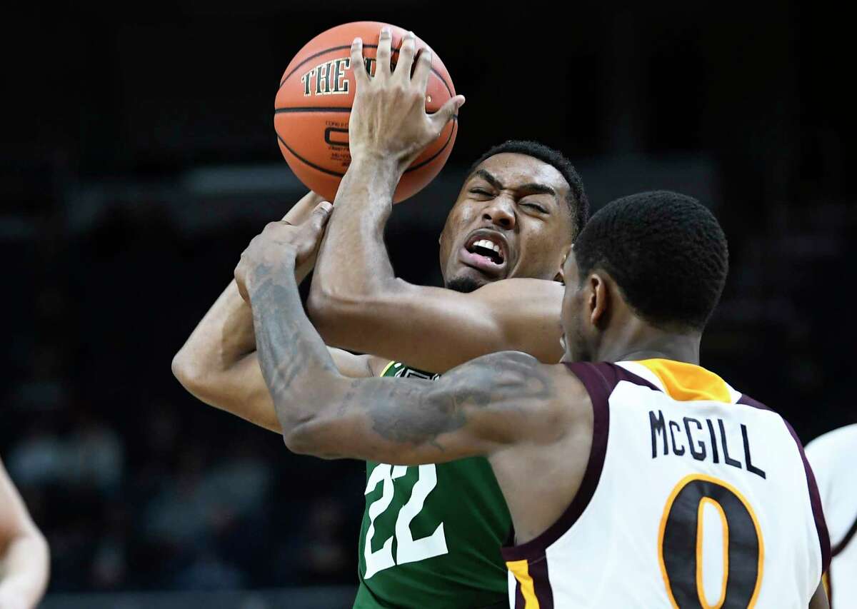 Siena Saints guard Jalen Pickett (22) is defended by Iona guard Rickey McGill (0) during a Metro Atlantic Athletic Conference NCAA semifinal basketball game Sunday, March 10, 2019, in Albany, N.Y. Iona won 73-57.