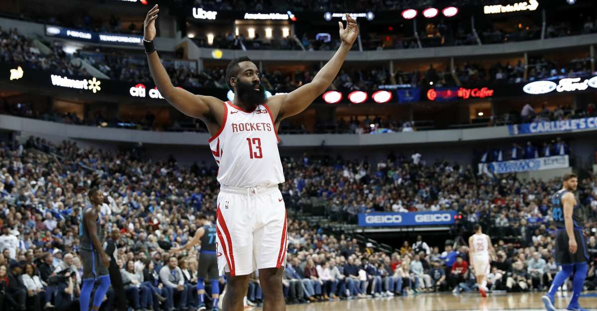 Houston Rockets guard James Harden (13) gestures to fans as they boo and cheer after the Rockets scored in the second half of an NBA basketball game against the Dallas Mavericks in Dallas, Sunday, March 10, 2019. (AP Photo/Tony Gutierrez)