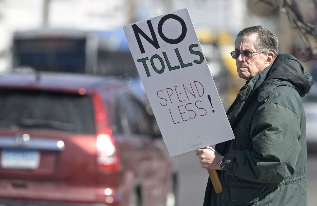 Harrison Pease, of Newtown, takes part in an anti-toll protest at the intersection of White and Wildman Streets on Saturday. The protest was organized by Stamford grassroots organization No Tolls Ct. March 9, 2019, in Danbury, Conn.