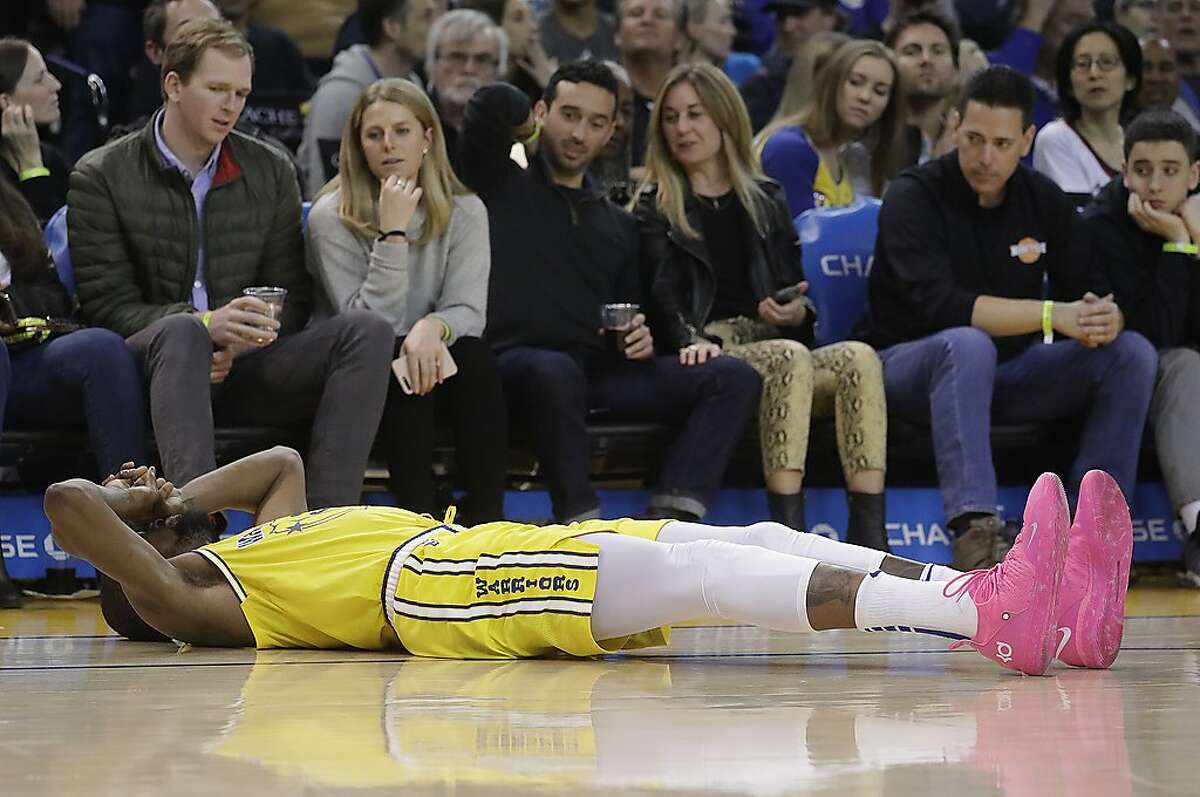 Golden State Warriors forward Kevin Durant reacts after injuring his ankle during the second half of an NBA basketball game against the Phoenix Suns in Oakland, Calif., Sunday, March 10, 2019. (AP Photo/Jeff Chiu)