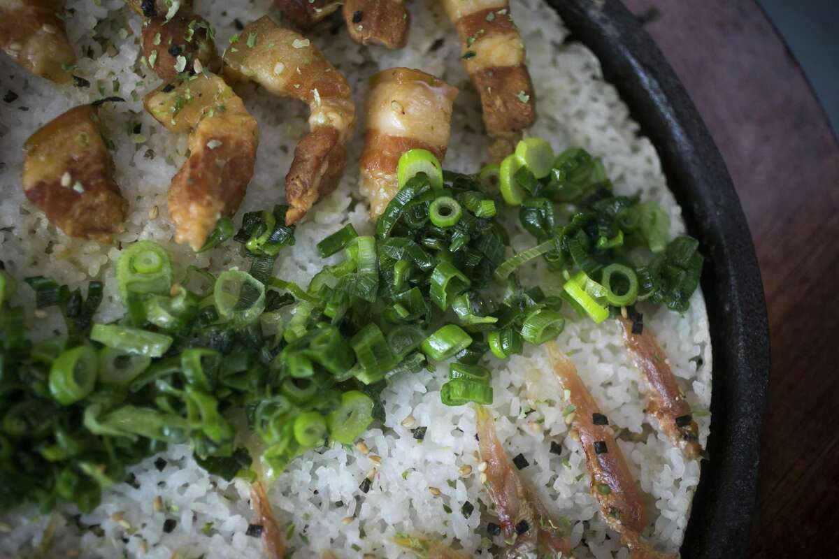 Grandma Subsidy at Kau Ba Saigon Kitchen features scorched rice, pork belly, grilled onions and fermented anchovies.