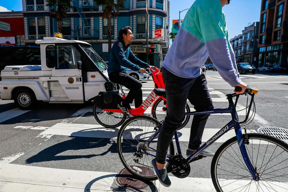 Bikers ride past 6th and Howard Streets where a cyclist was killed last Friday after being struck by a vehicle in San Francisco, California, on Monday, March 11, 2019
