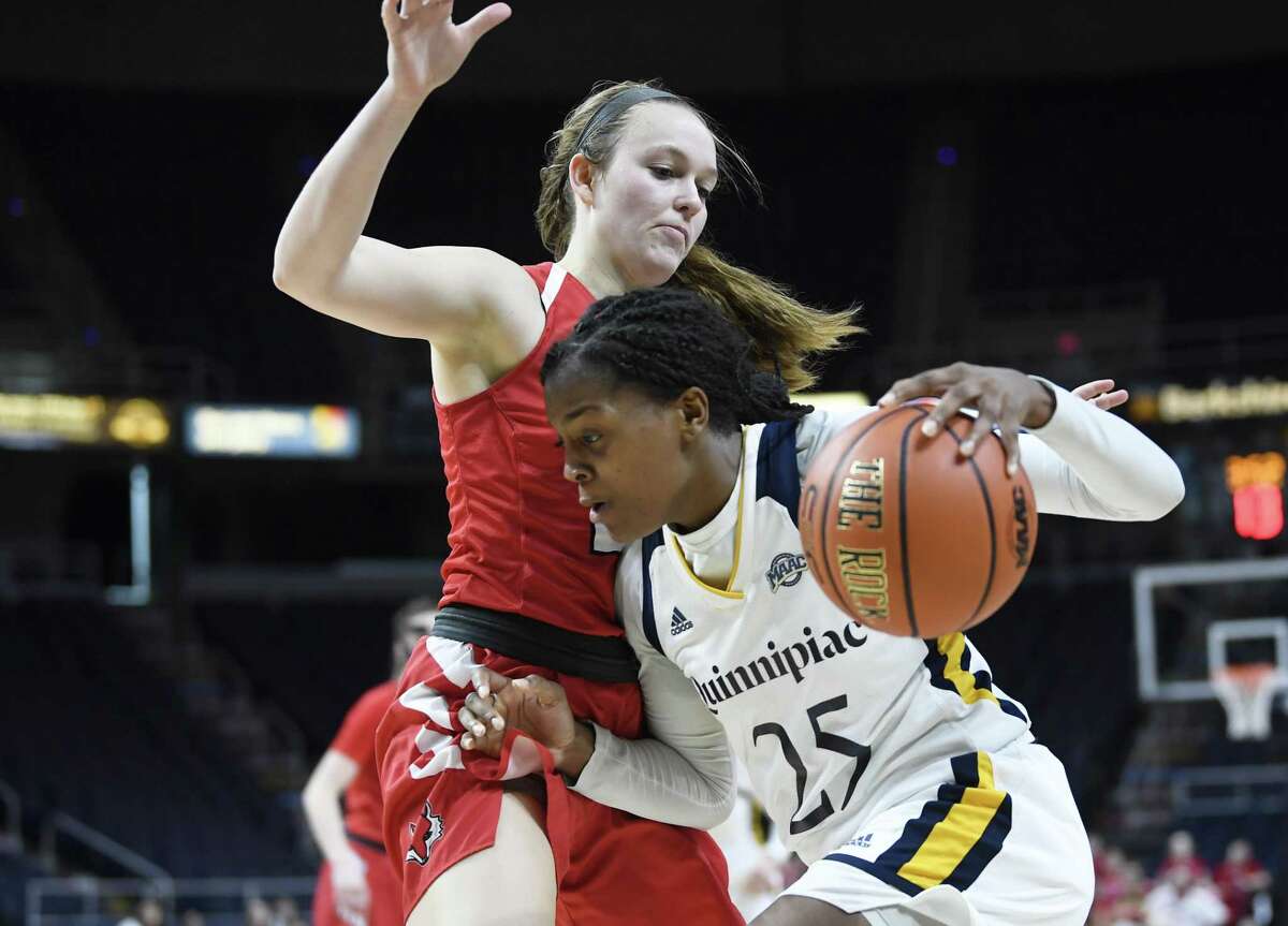 Quinnipiac guard Aryn McClure (25) moves the ball in front of Marist guard Rebekah Hand (23) during the MAAC Tournament championship March 11.
