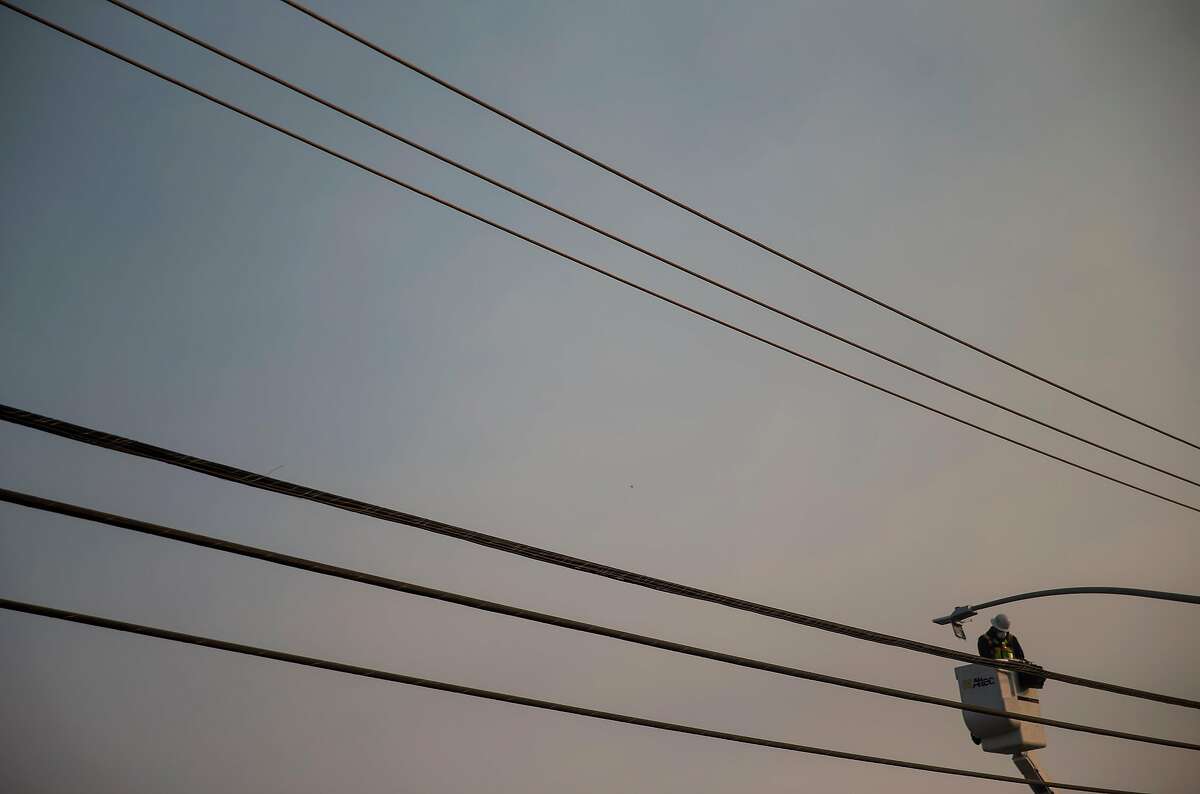 FILE — A utility worker repairs a power line in Paradise, Calif., Nov. 16, 2018, after the Camp Fire, the state’s deadliest wildfire, which led to an investigation of Pacific Gas & Electric's responsibility. PG&E, which filed for bankruptcy in January, has been blamed for deadly explosions and wildfires, but lawmakers continue to benefit from political donations from the company. (Eric Thayer/The New York Times)