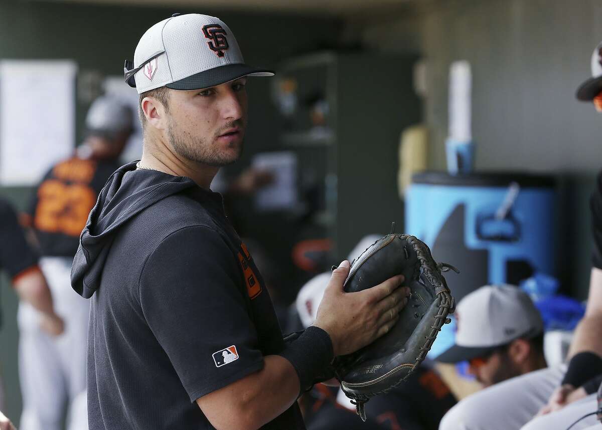 San Francisco Giants' Joey Bart talks with teammates in the dugout prior to the team's spring training baseball game game against the Texas Rangers Wednesday, March 6, 2019, in Surprise, Ariz. (AP Photo/Ross D. Franklin)