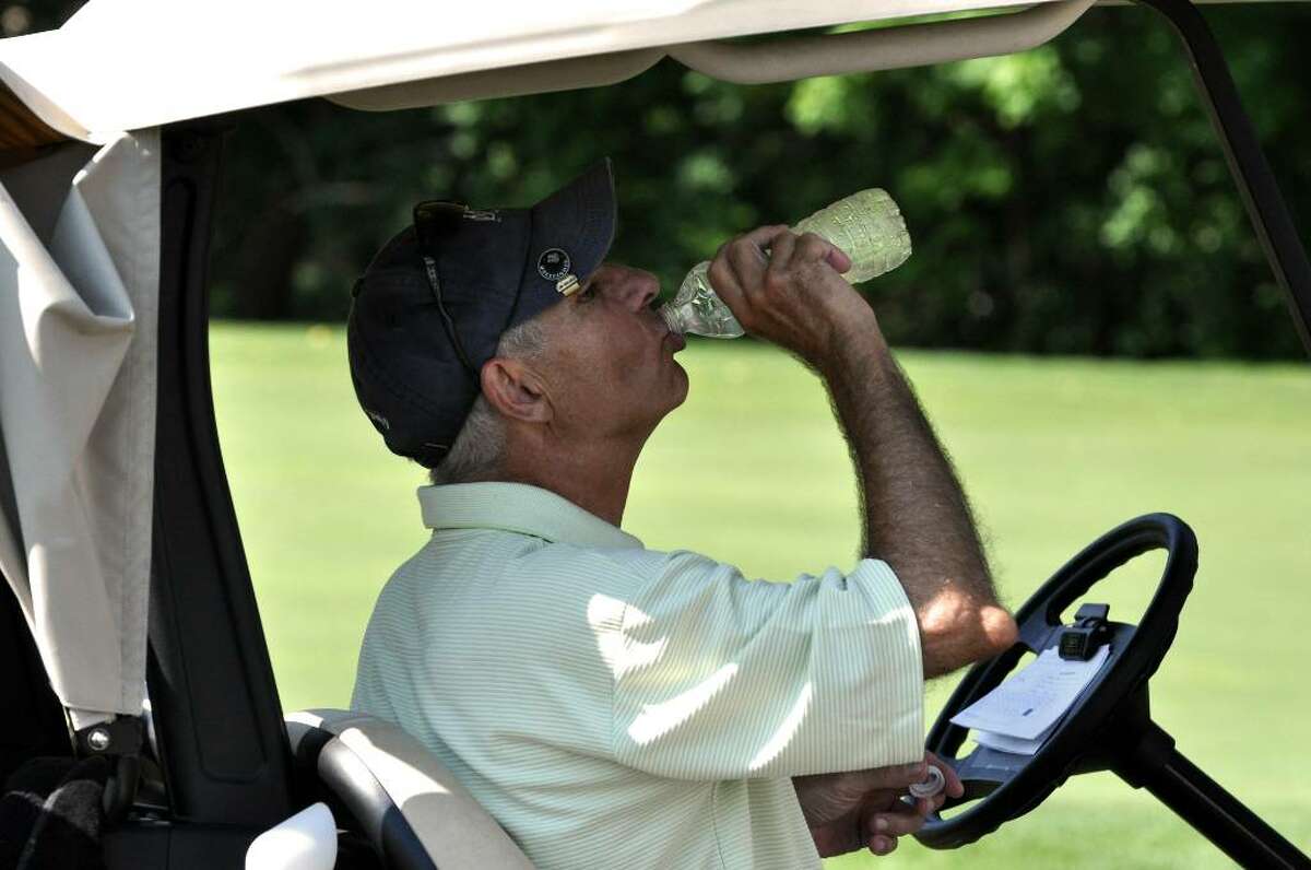 Pete Silver, Senior Division, rehydrates at the 18th hole during the City Golf Tournament at E Gaynor Brennan Golf Course on Stillwater Road in Stamford on Saturday, July 24, 2010.