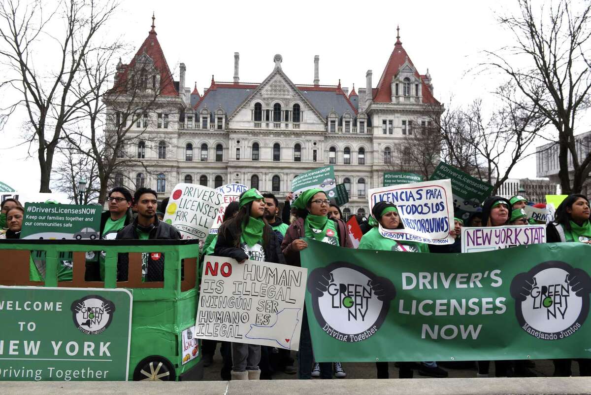 Protesters with the Green Light Campaign to get driver licenses for undocumented immigrants, take part in a rally in West Capitol Park on Tuesday, March 12, 2019, in Albany, N.Y. New York currently bars immigrants from obtaining a license due to their immigration status. (Will Waldron/Times Union)