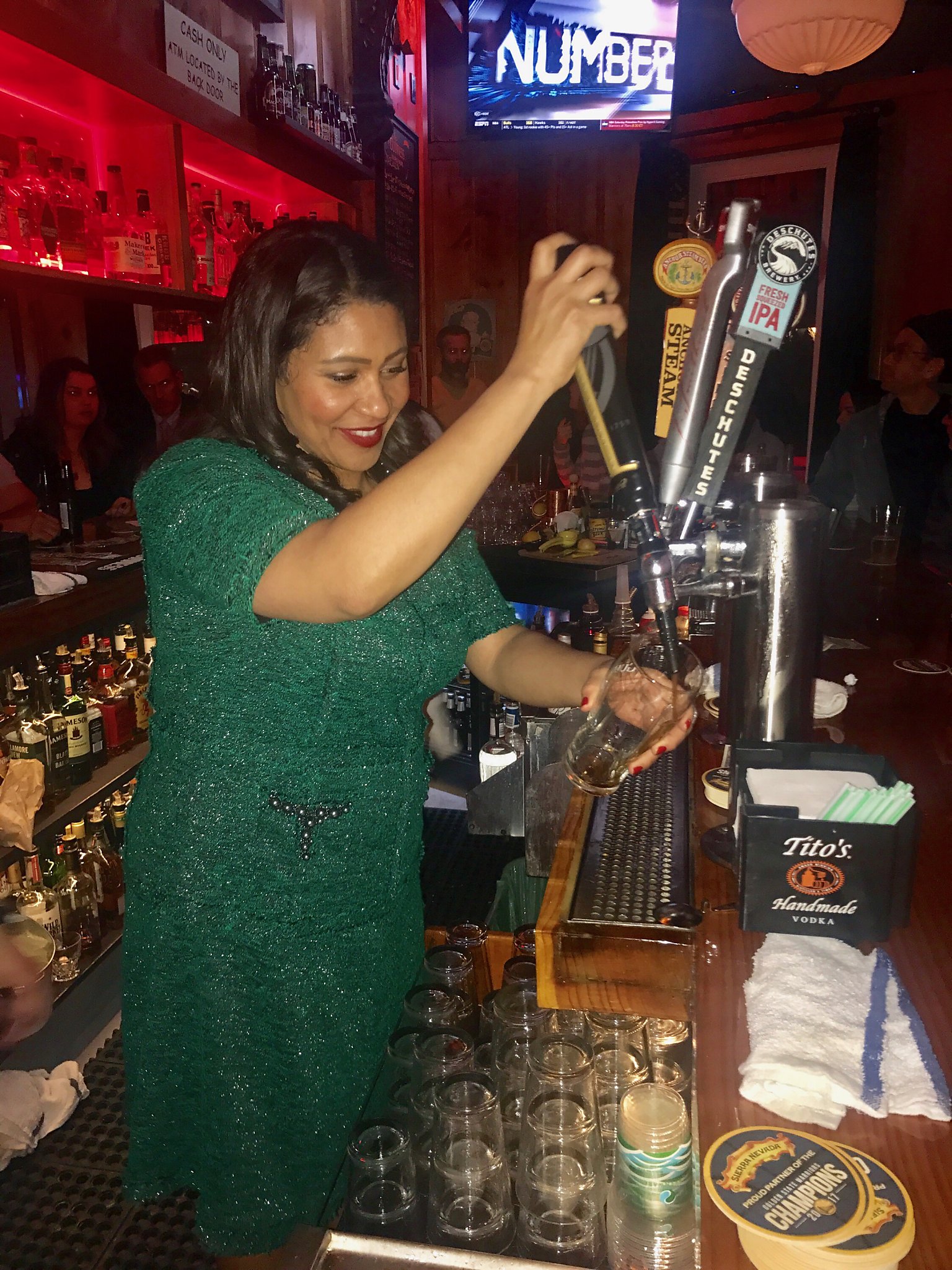 SF Mayor London Breed shows her green and does her time behind the bar